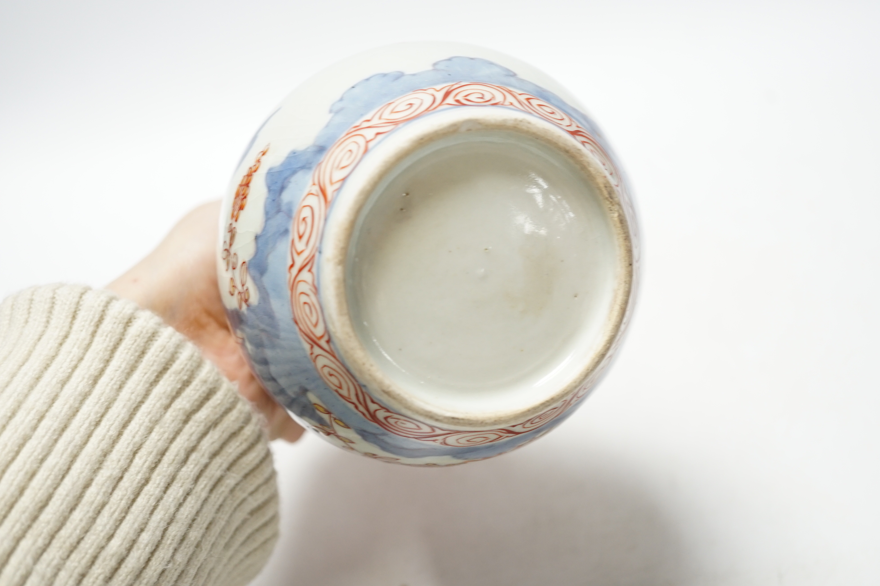 An 18th century Japanese Imari sake flask and a Chinese clobbered blue and white bowl (a.f), tallest 20cm